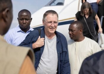 Missionary arriving safely at an airport reception in West Africa after release from captivity