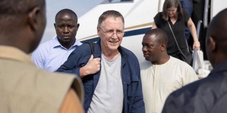 Missionary arriving safely at an airport reception in West Africa after release from captivity