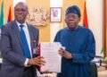 President Bola Ahmed Tinubu with Abel Enitan during the Head of Civil Service handover ceremony