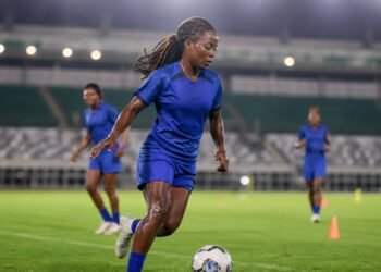 Nigerian female football midfielder training