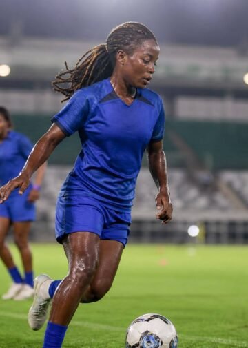 Nigerian female football midfielder training