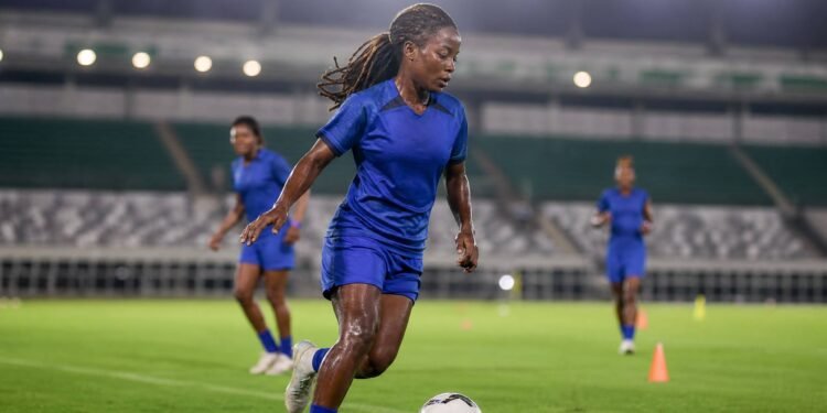 Nigerian female football midfielder training