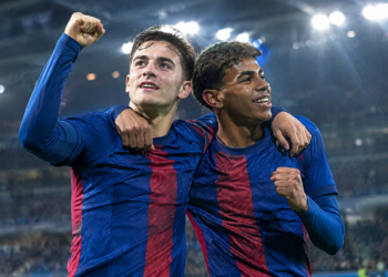 Football teammates celebrating under stadium floodlights during award season