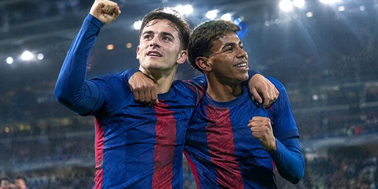 Football teammates celebrating under stadium floodlights during award season