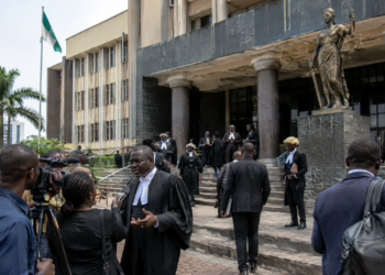 Nigerian appellate court exterior with lawyers and journalists
