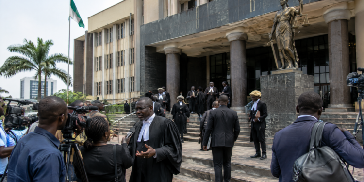 Nigerian appellate court exterior with lawyers and journalists