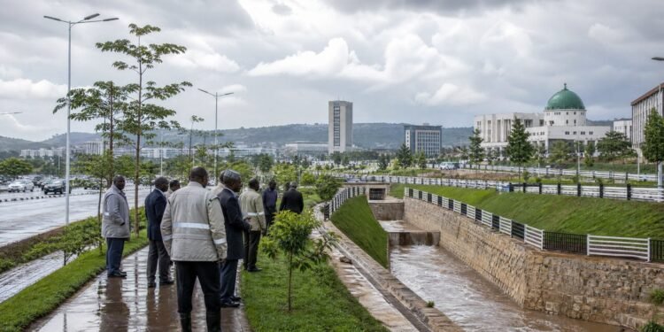 Officials inspect a drainage corridor and protected green area in Abuja after rainfall