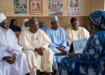 Traditional leaders listen to a public-health worker during a vaccination meeting in Kano