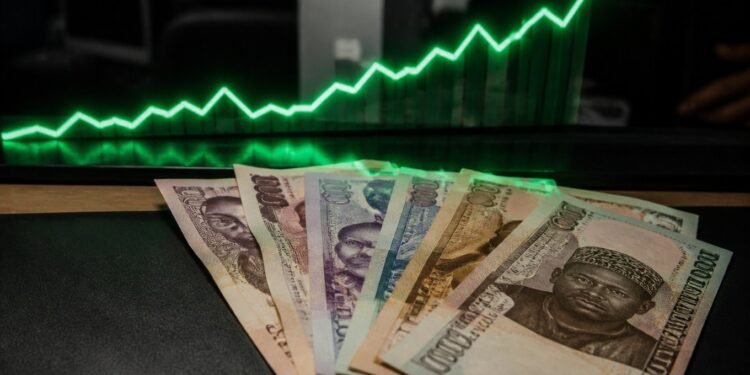 Nigerian naira banknotes with a rising green chart arrow in the background