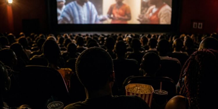 Audience silhouettes with popcorn inside a busy Nigerian cinema hall, screen glowing